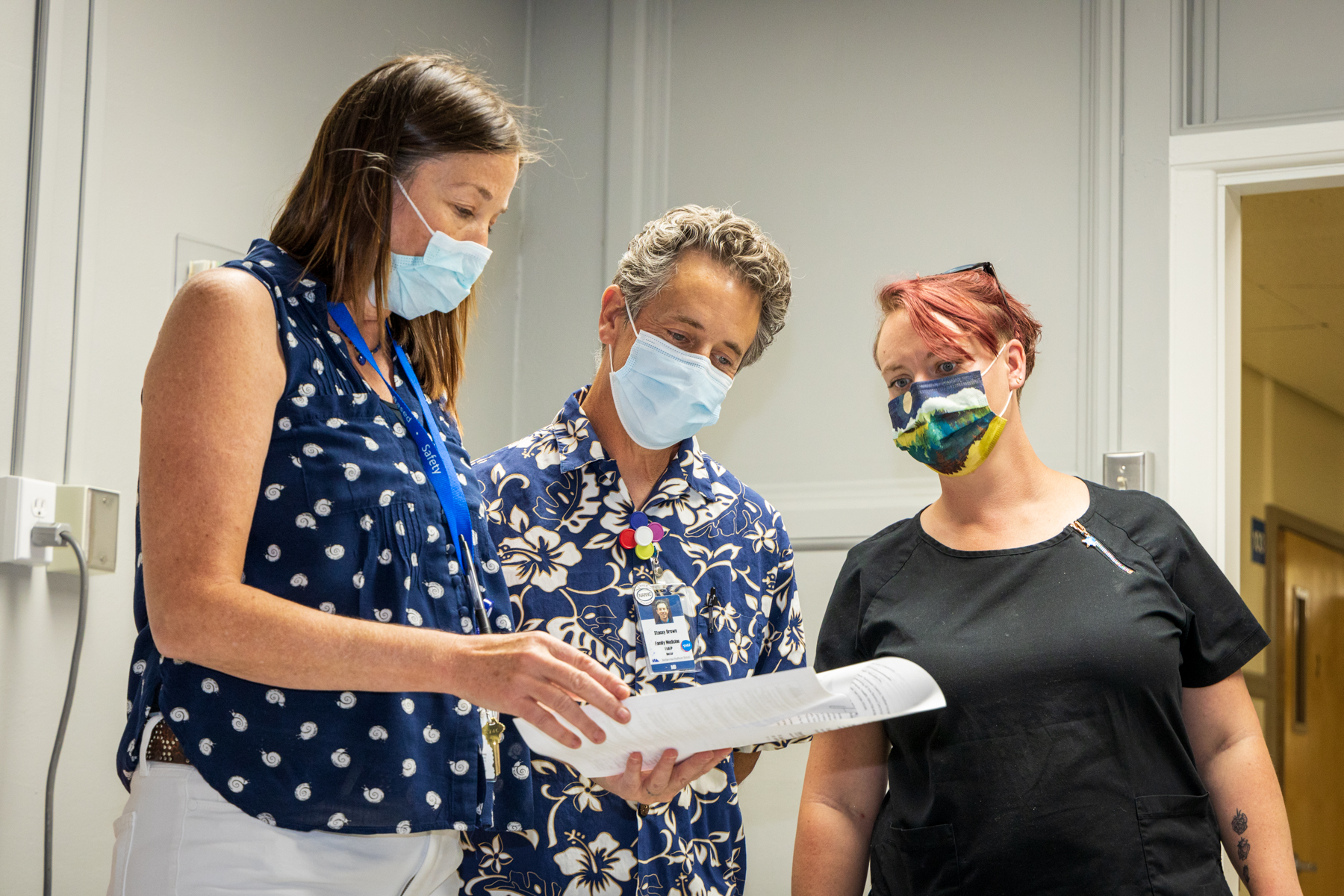 Nurse Practitioner Colleen McEvoy, Dr. Stacey Brown, and Medical Assistant Kaylyn Rickford review the day's schedule. Photo by Scot Swan